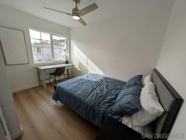 a bed sitting in a bedroom next to a window