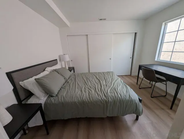 a bedroom with a bed and chair