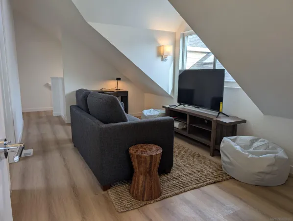 a living room with furniture a flat screen tv and rug