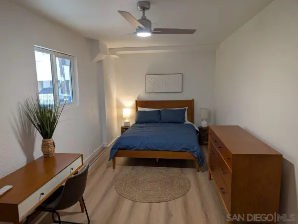 a bedroom with a bed and a desk