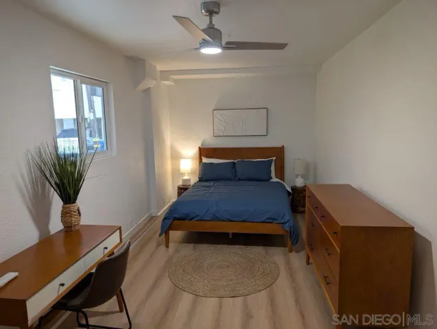 a bedroom with a bed and a desk