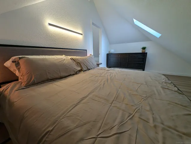 a large bed sitting in a bedroom and dressers