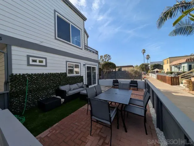 a view of a patio with a table and chairs