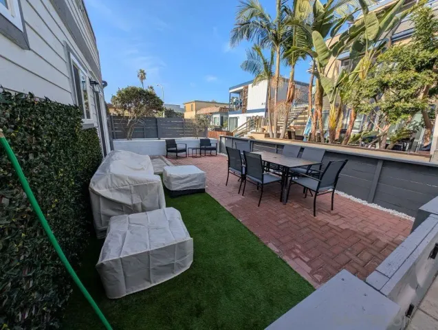 a view of a backyard with sitting area