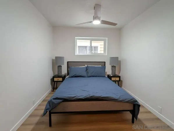 a bedroom with a bed and a window