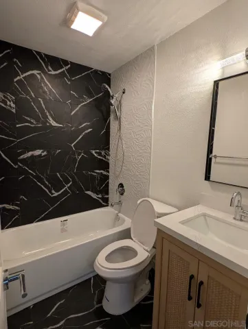 a bathroom with a toilet and a bathtub