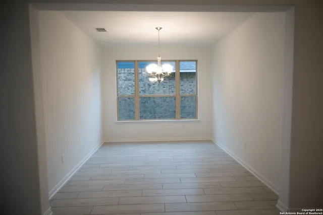 an empty room with windows and entrance