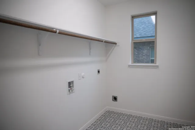 a view of staircase with lots of frames on wall and wooden floor
