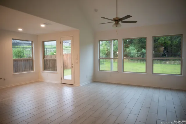 a kitchen with stainless steel appliances granite countertop a sink a stove and a wooden floors