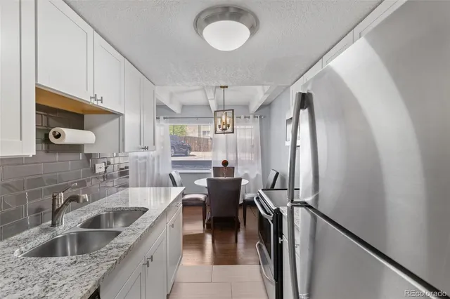 a kitchen with sink cabinets and refrigerator