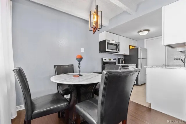 a view of a dining room with furniture and a chandelier