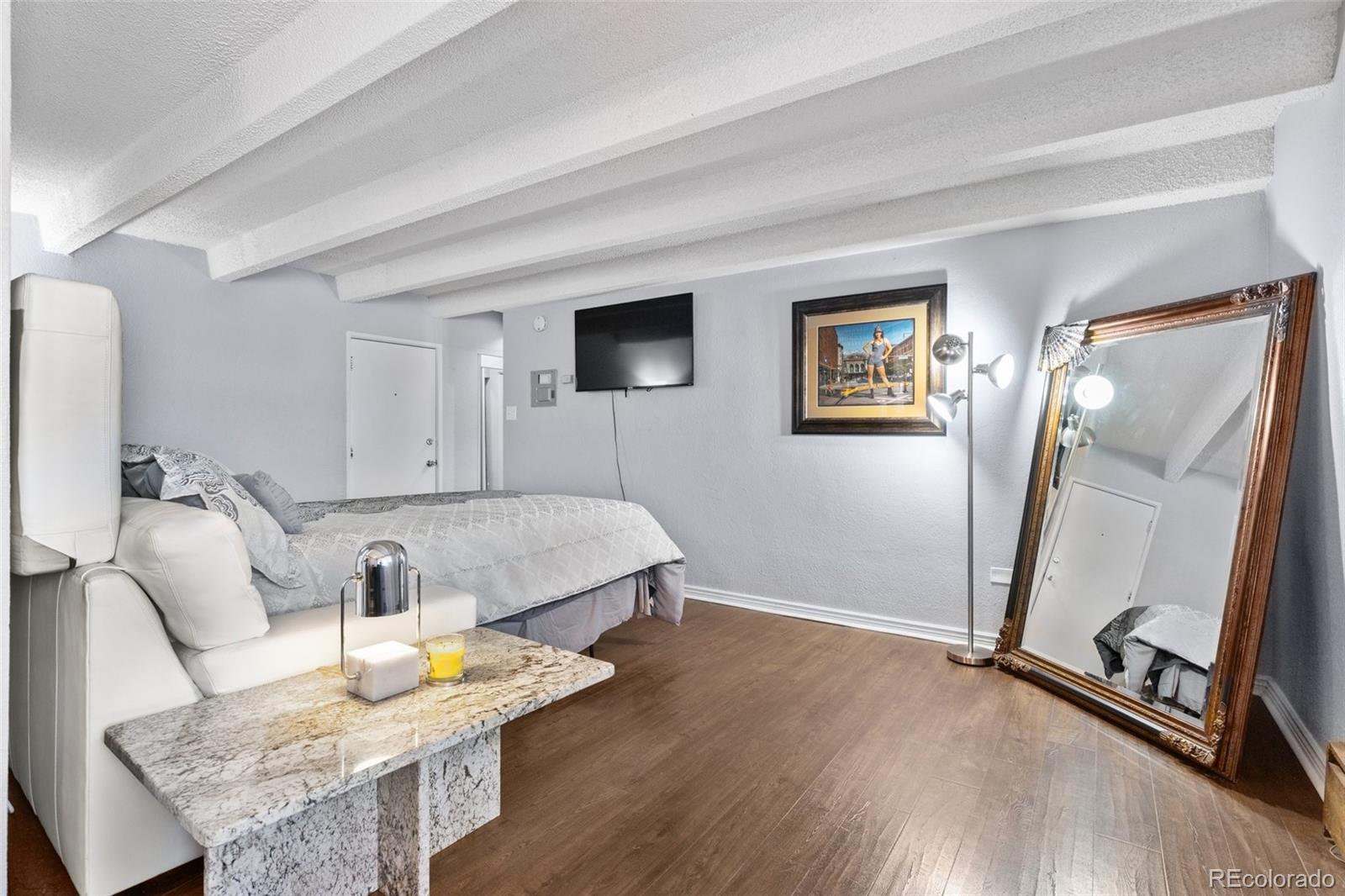 200 Pearl Street, Unit 106 Denver, CO 80203 - Photo 6 of 16 a room with furniture and a window