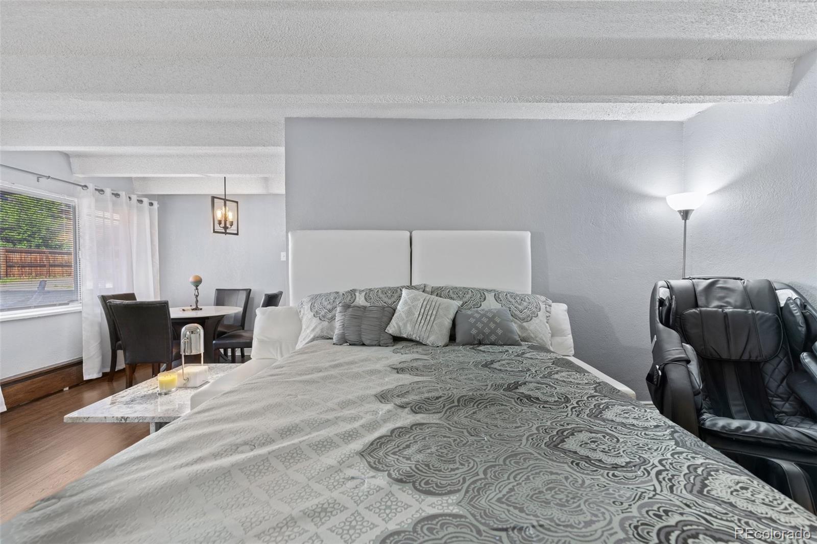 200 Pearl Street, Unit 106 Denver, CO 80203 - Photo 8 of 16 a bedroom with a bed and a window