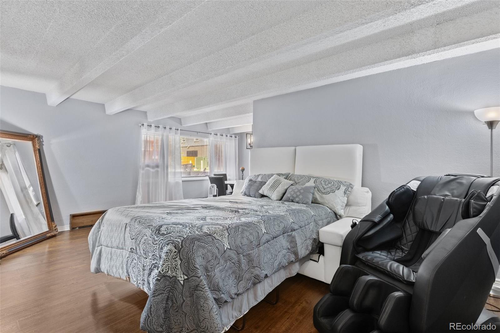 200 Pearl Street, Unit 106 Denver, CO 80203 - Photo 9 of 16 a bedroom with a bed and a couch