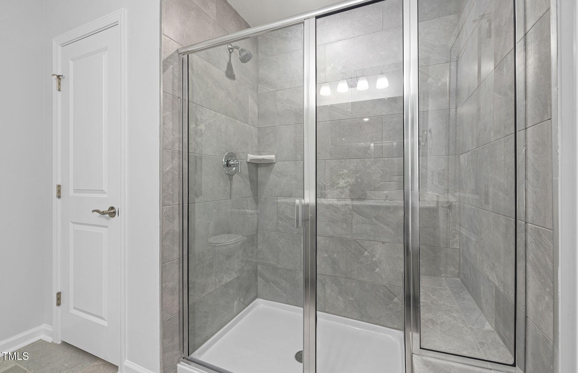 1005 Freestone Road Durham, NC 27703 - Photo 13 of 20 a bathroom with a glass shower door