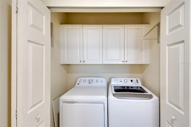 a view of washer and dryer with kitchen in the background