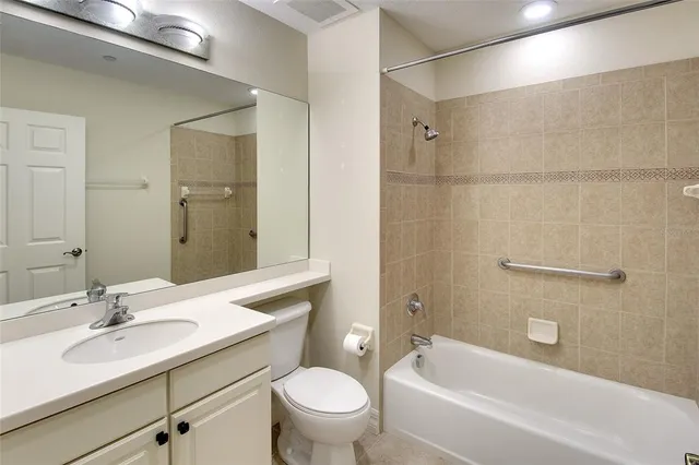 a bathroom with a sink toilet vanity and shower
