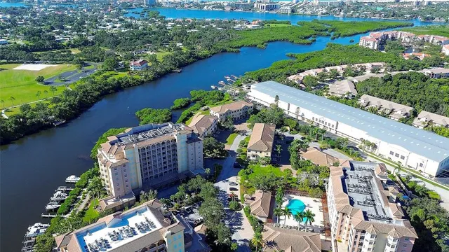 an aerial view of a city with lots of residential buildings ocean and mountain view in back