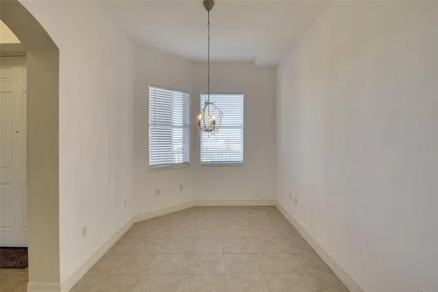 a view of a room that has a window and a ceiling fan