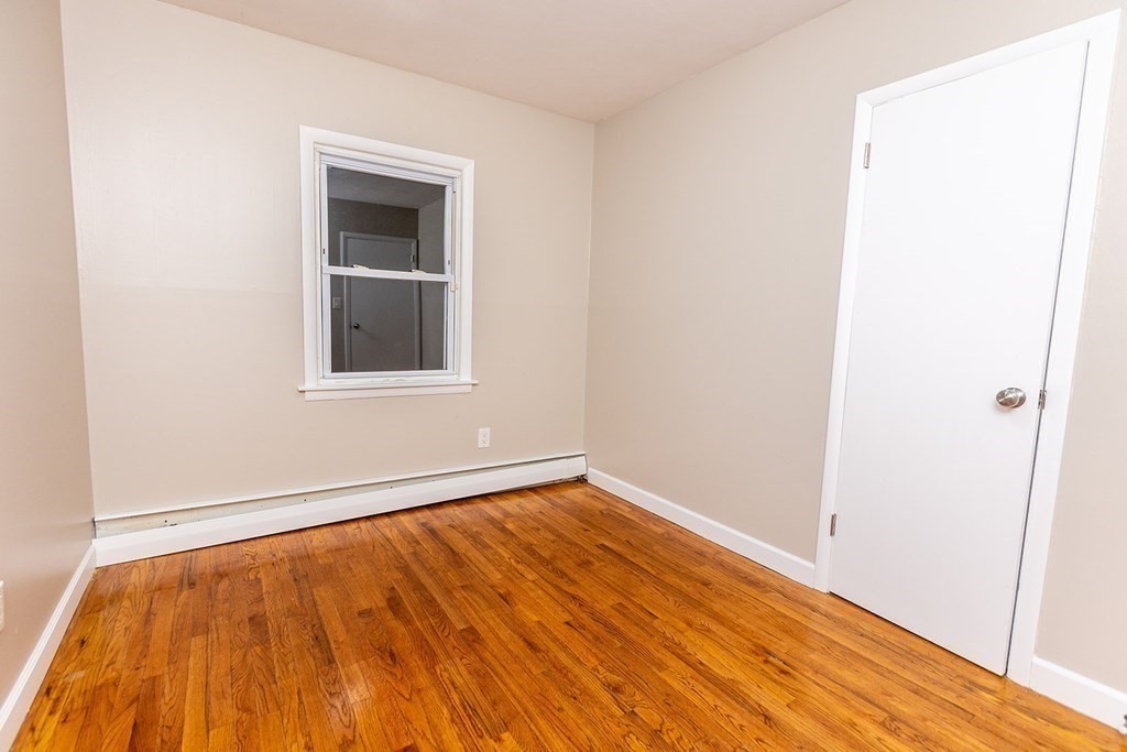 376 Hermitage Drive Springfield, MA 01129 - Photo 12 of 34 a view of an empty room with wooden floor and a window