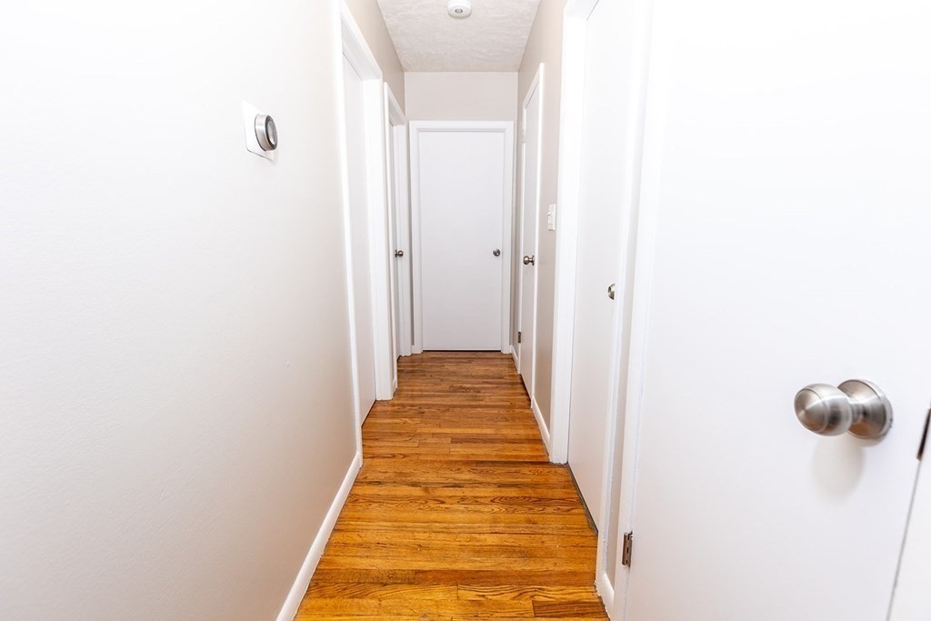 376 Hermitage Drive Springfield, MA 01129 - Photo 23 of 34 a view of a hallway with wooden floor