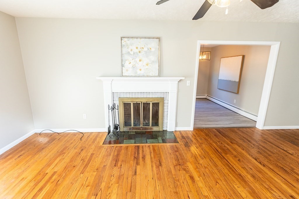 376 Hermitage Drive Springfield, MA 01129 - Photo 7 of 34 a view of empty room with wooden floor and fireplace
