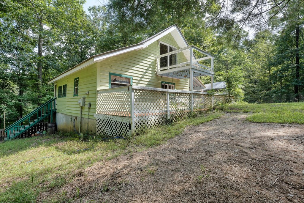 51 Cold Springs Trail Morganton, GA 30560 - Photo 28 of 40 a view of a house with a yard and tree in the background