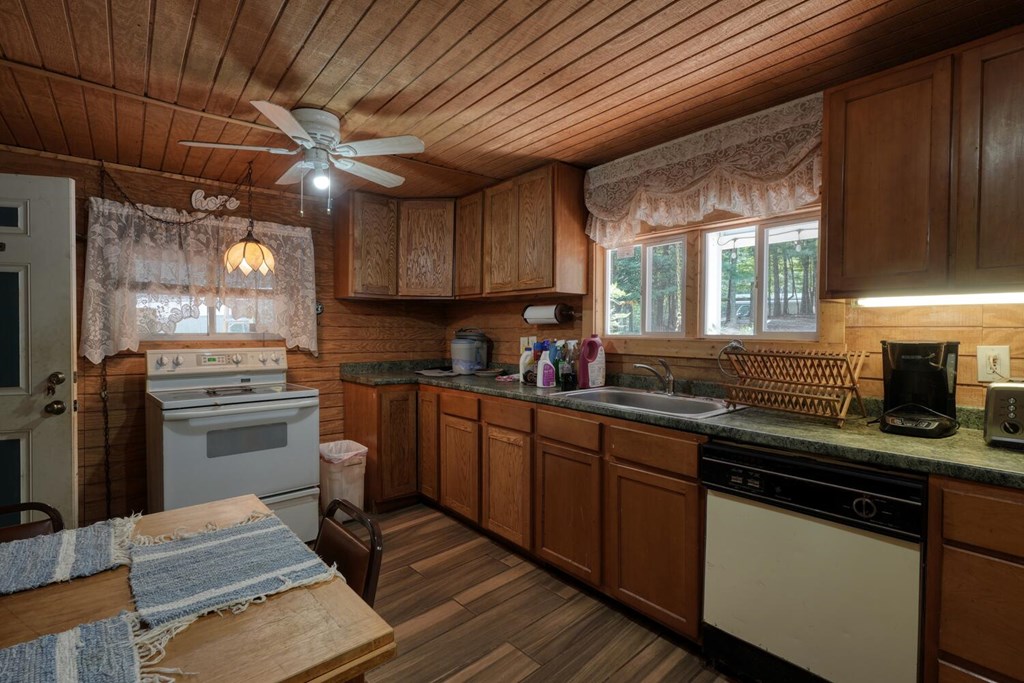 51 Cold Springs Trail Morganton, GA 30560 - Photo 32 of 40 a kitchen with stainless steel appliances granite countertop wooden cabinets sink stove and refrigerator