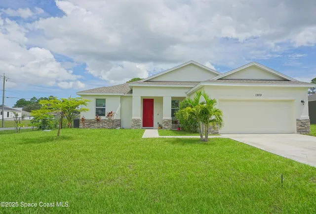 a front view of house with yard and green space
