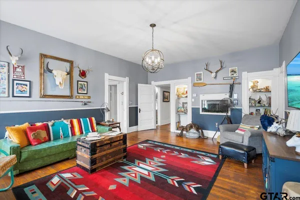 a living room with furniture dining table and a flat screen tv
