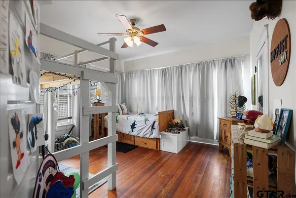 a view of a hallway with wooden floor and a large window
