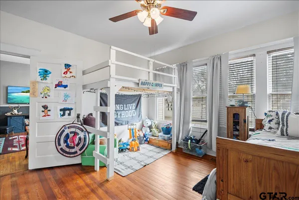 a spacious bedroom with a bed and a chandelier