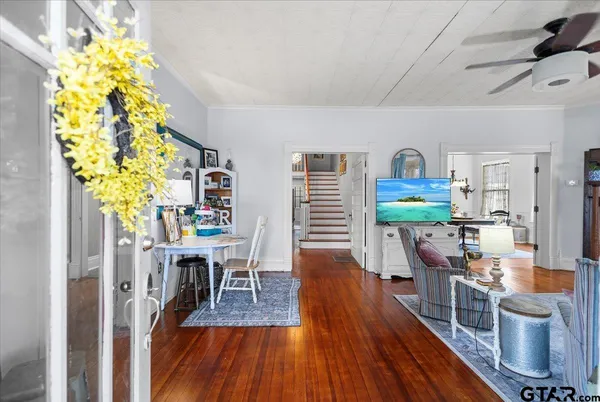 a living room with furniture and a chandelier