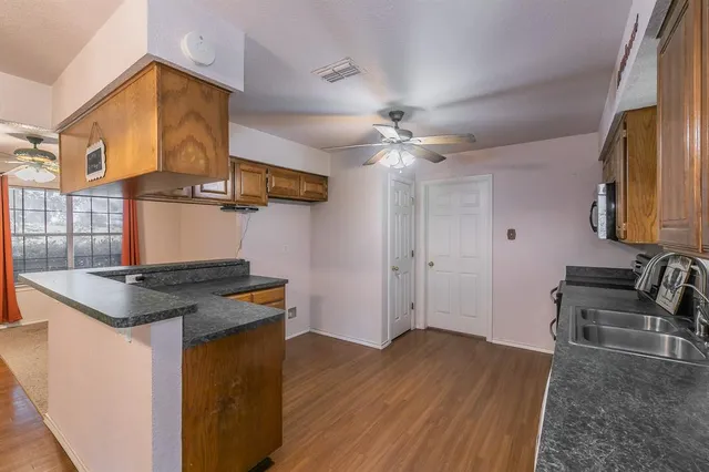 a kitchen that has a sink and a stove in it