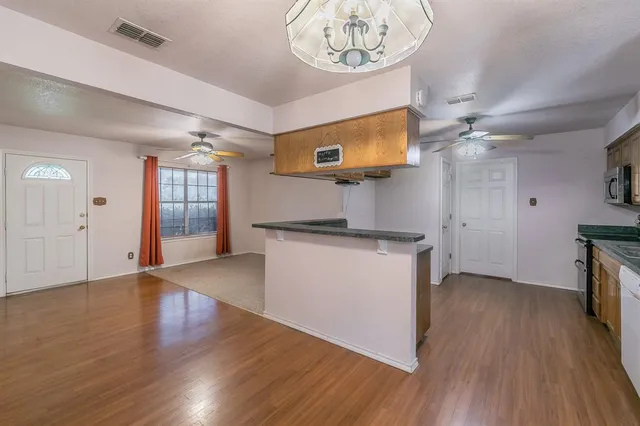 a view of a room with wooden floor