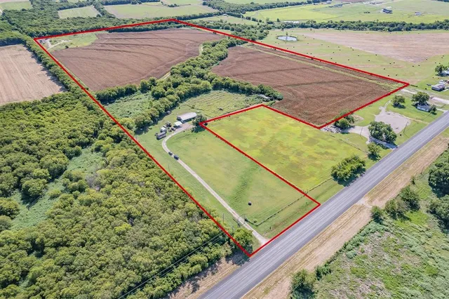 a view of a backyard with wooden fence