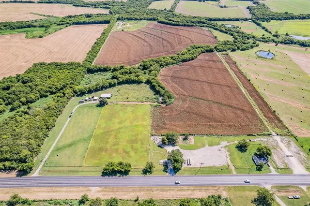 an aerial view of residential house with pool and lawn chairs