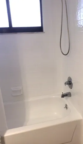 a bathroom with a tub and a shower