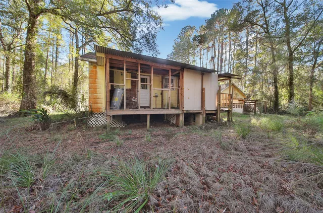 a view of a house with a yard and sitting area