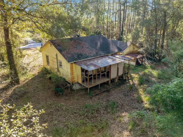 a aerial view of a house with a yard