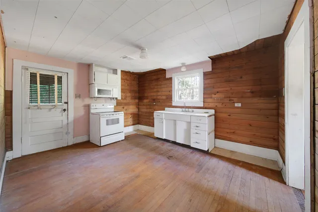 a kitchen with stainless steel appliances a stove top oven and a refrigerator