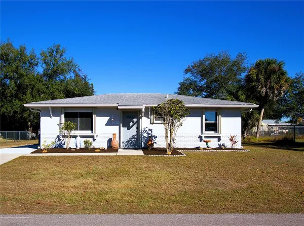 a front view of a house with outdoor seating