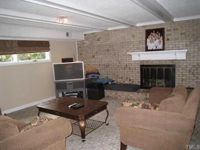 1029 Hemingway Drive Raleigh, NC 27609 - Photo 3 of 12 a living room with furniture and a fireplace