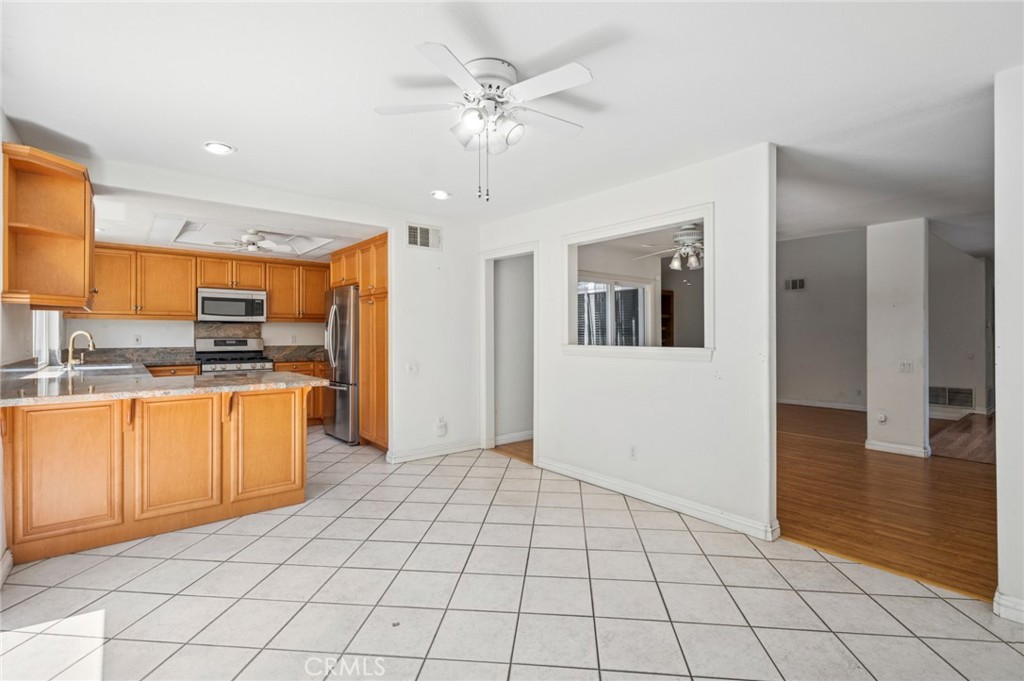 10 Sandpiper Irvine, CA 92604 - Photo 19 of 30 a view of a kitchen with kitchen island granite countertop a refrigerator and a sink