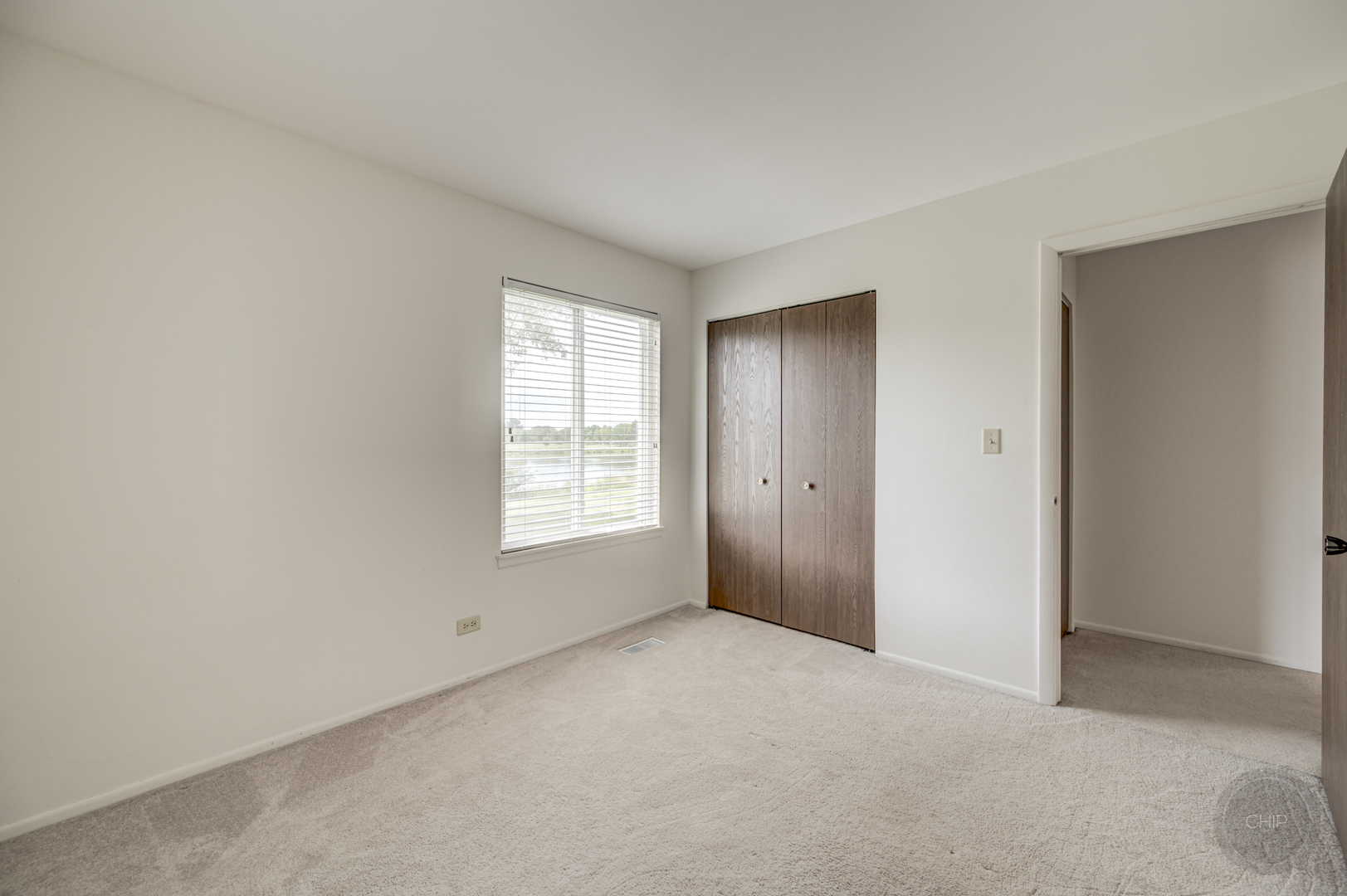 360 Springlake Lane, Unit B Aurora, IL 60504 - Photo 17 of 26 a view of an empty room with a window