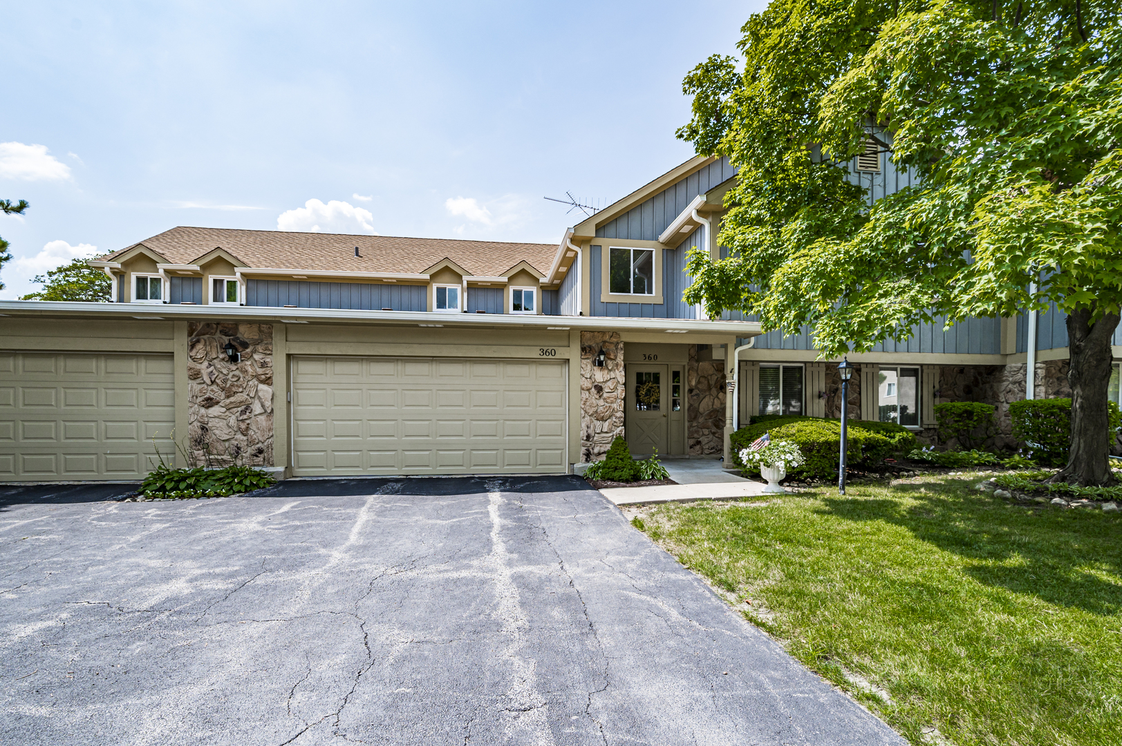 360 Springlake Lane, Unit B Aurora, IL 60504 - Photo 2 of 26 a view of a house with a yard and garage