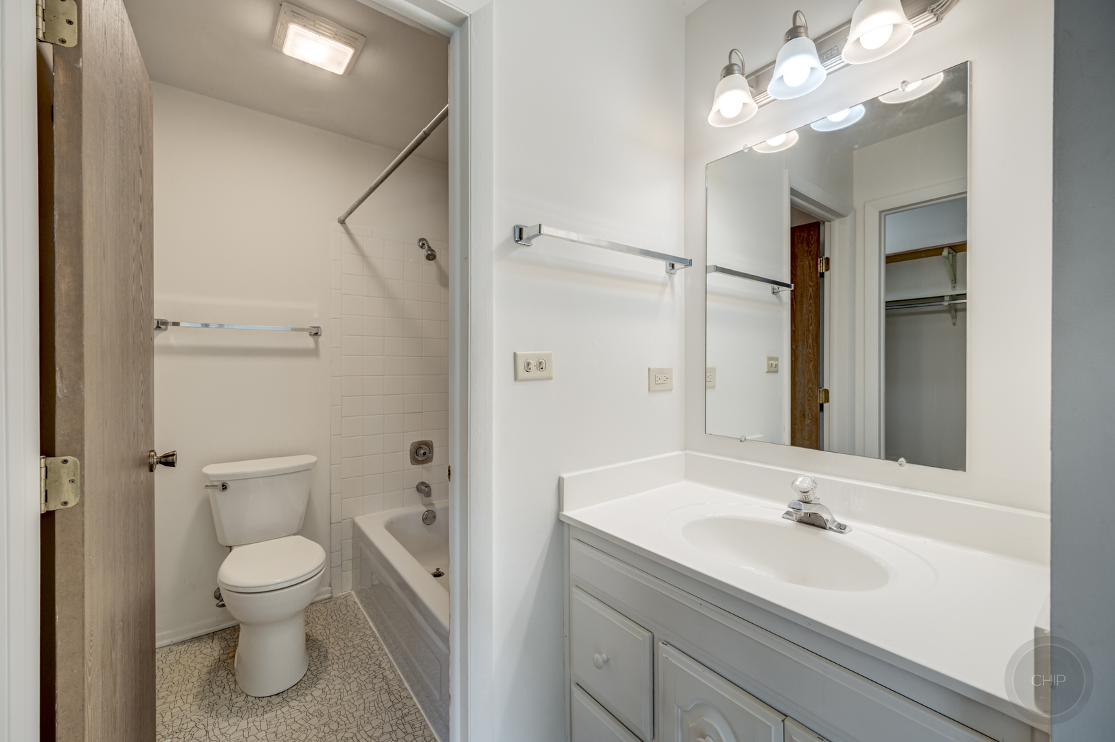 360 Springlake Lane, Unit B Aurora, IL 60504 - Photo 21 of 26 a bathroom with a toilet a sink and a mirror