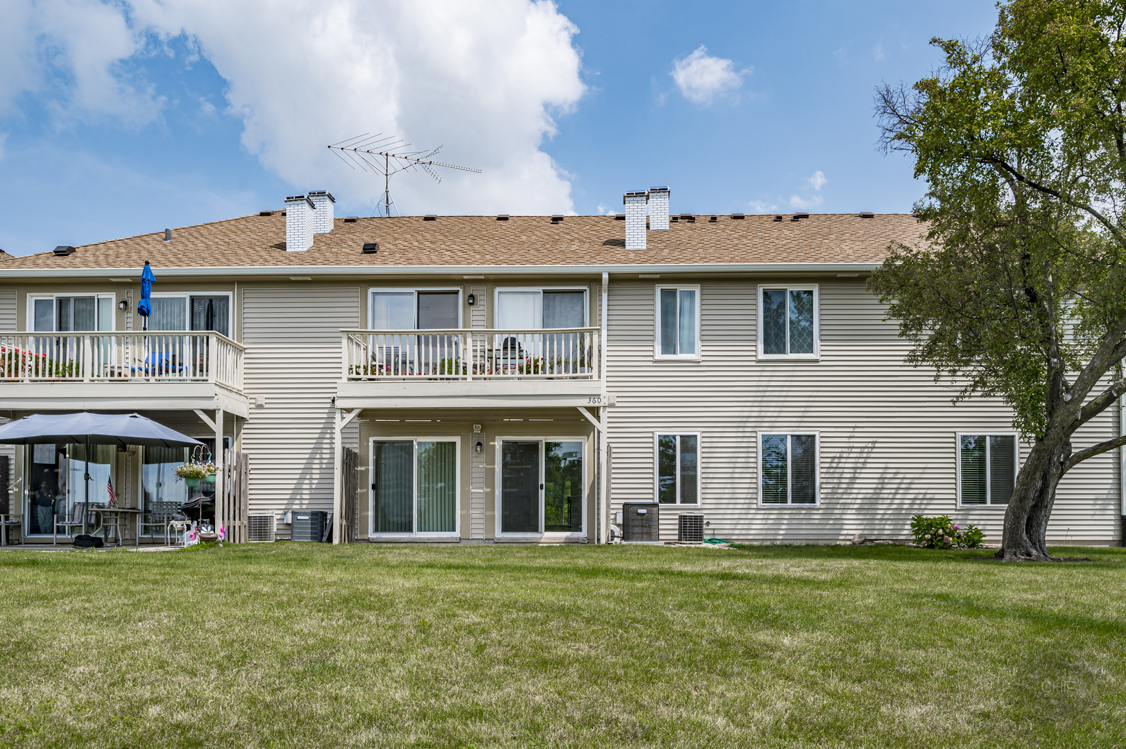 360 Springlake Lane, Unit B Aurora, IL 60504 - Photo 23 of 26 front view of a brick house with a yard