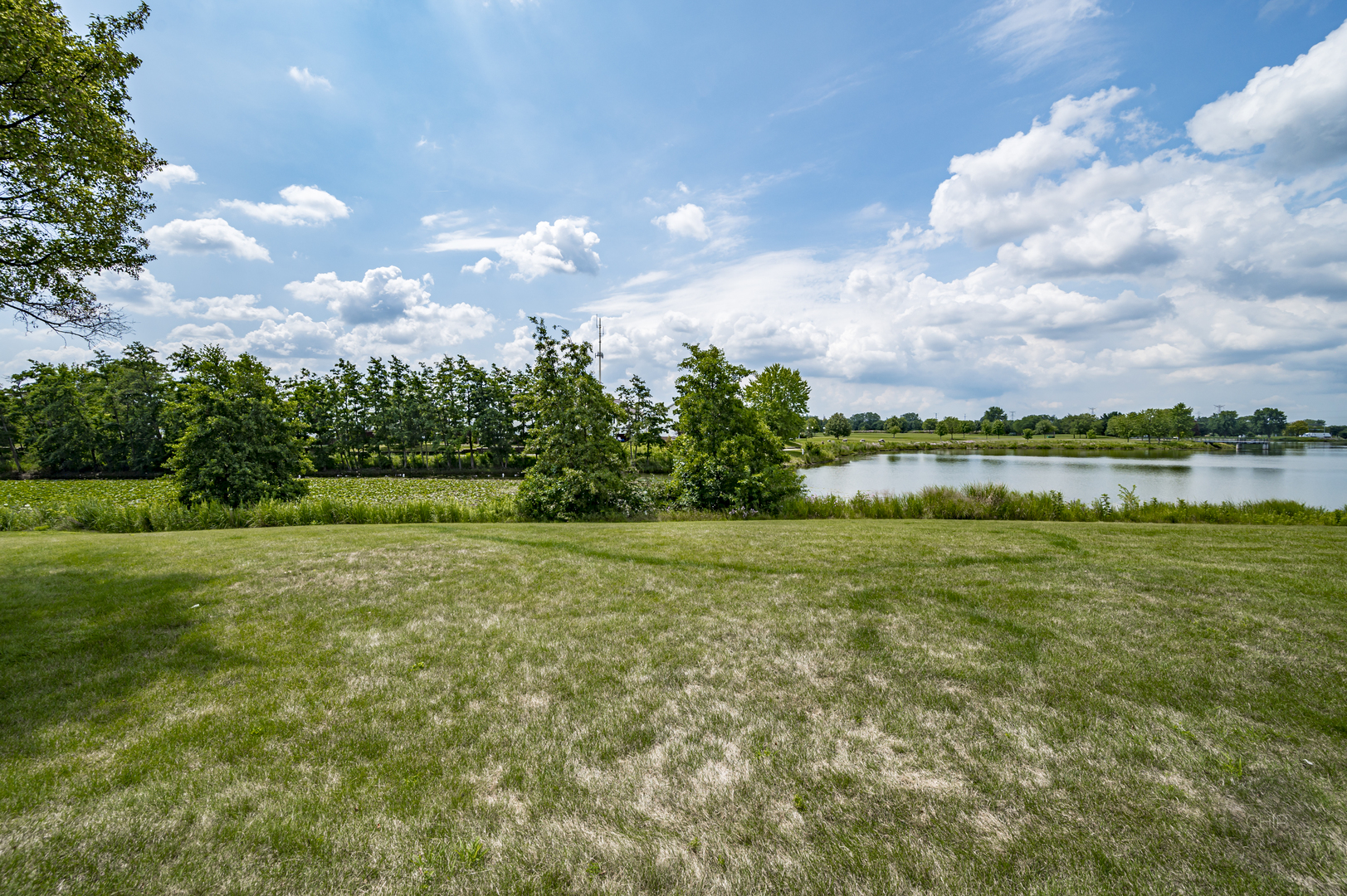 360 Springlake Lane, Unit B Aurora, IL 60504 - Photo 26 of 26 a view of a lake with houses in the background