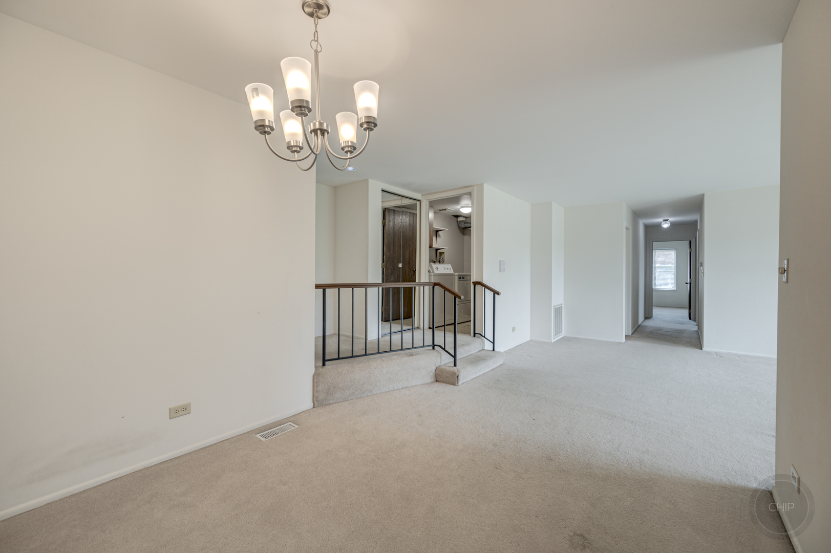 360 Springlake Lane, Unit B Aurora, IL 60504 - Photo 7 of 26 a view of a hallway with chandelier